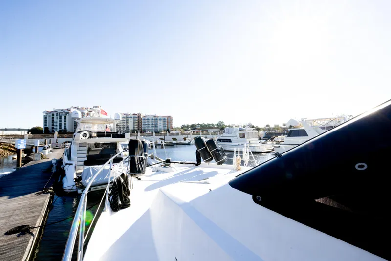 Slide: The Image of 1989 Viking 63 Motor Yacht docked at marina with other boats. - 48