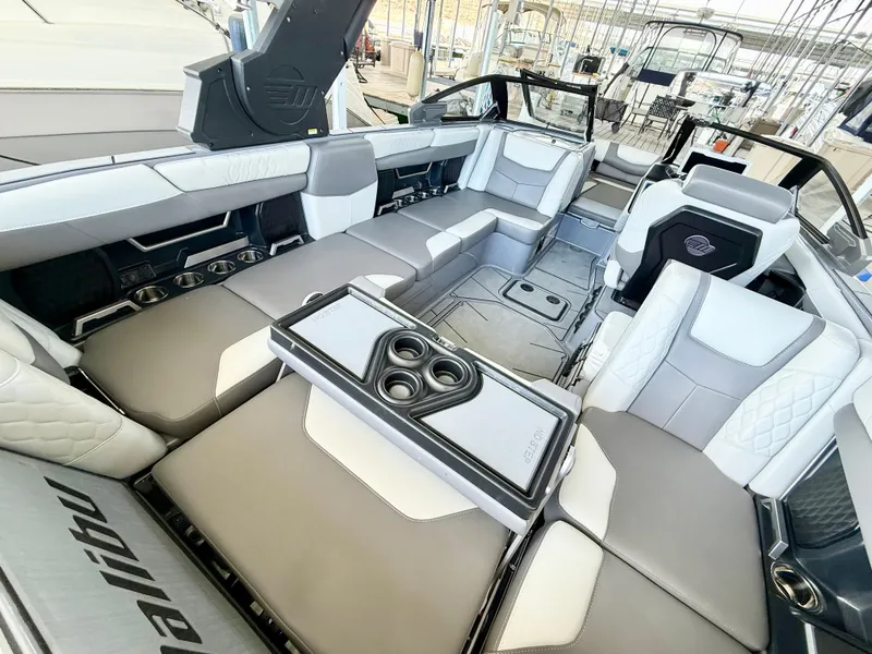 Slide: The Image of Luxurious interior of 2021 Malibu M240 boat with spacious seating and cup holders. - 15