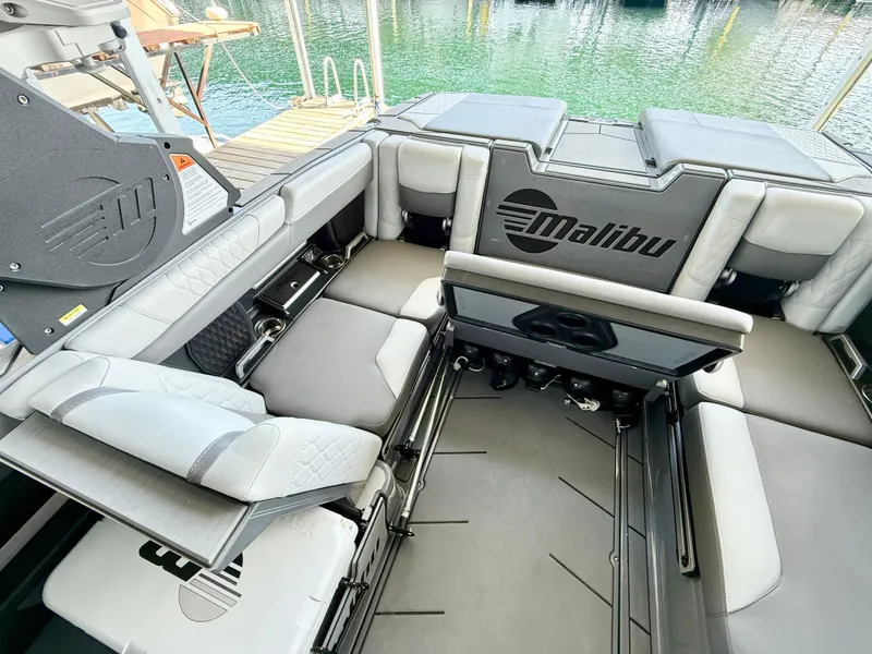 Slide: The Image of 2021 Malibu M240 boat interior with luxurious seating and sleek design. - 19