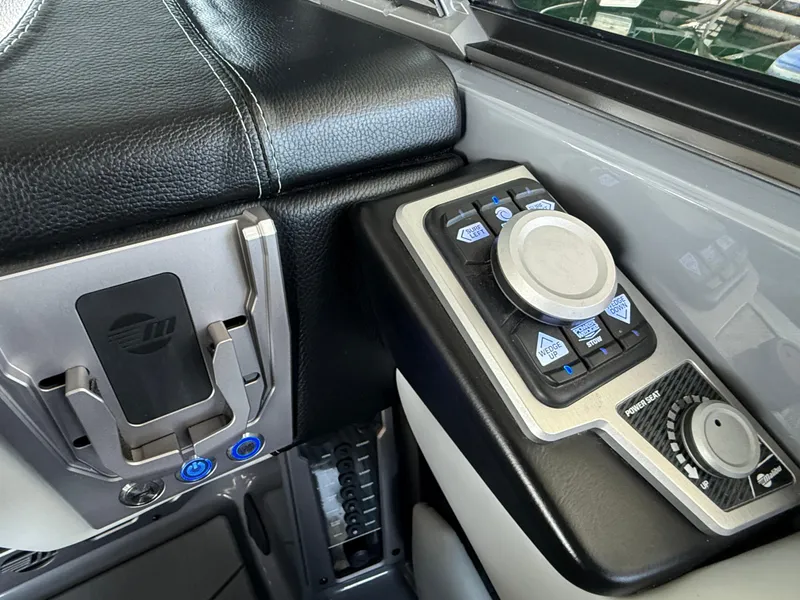 Slide: The Image of 2021 Malibu M240 boat control panel with modern navigation and adjustment features. - 29