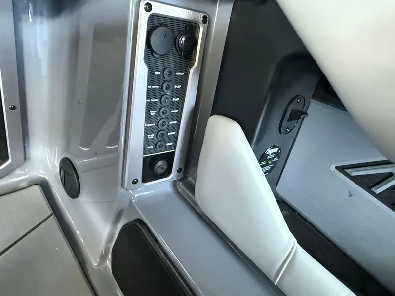 Slide: The Image of 2021 Malibu M240 boat interior with control panel and seating. - 30