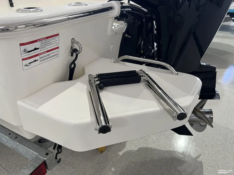 Slide: The Image of 2025 Boston Whaler 170 Montauk swim platform with foldable ladder and safety warnings. - 11