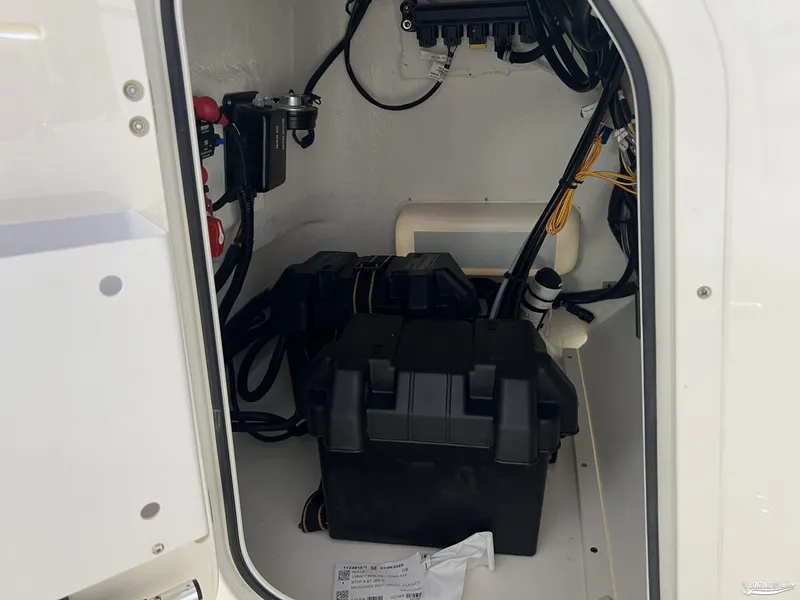 Slide: The Image of 2025 Boston Whaler 170 Montauk battery compartment with wiring and components. - 12