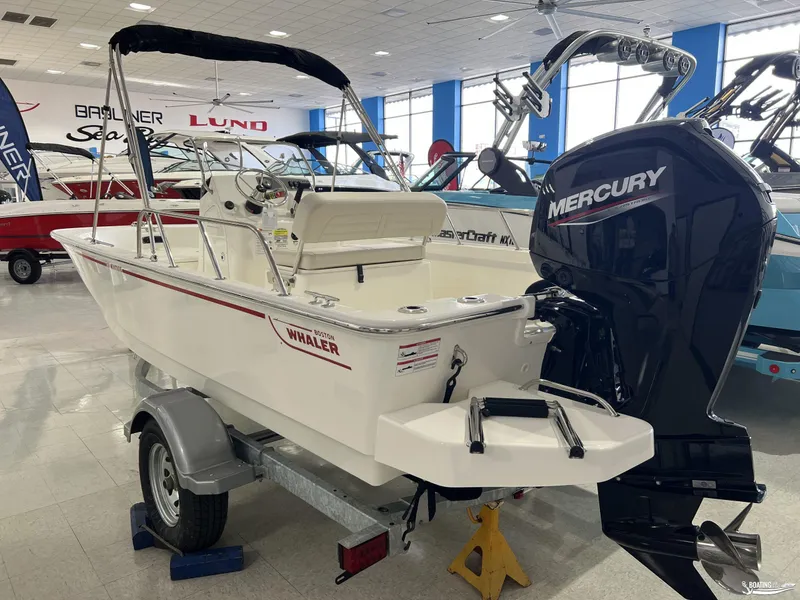 Slide: The Image of 2025 Boston Whaler 170 Montauk boat with Mercury engine displayed in showroom. - 2