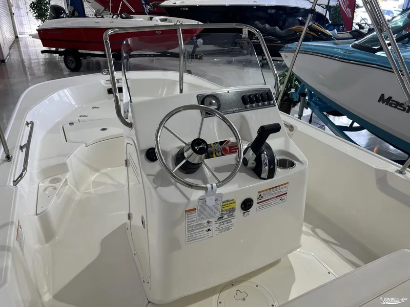 Slide: The Image of 2025 Boston Whaler 170 Montauk boat interior with steering console and controls. - 4