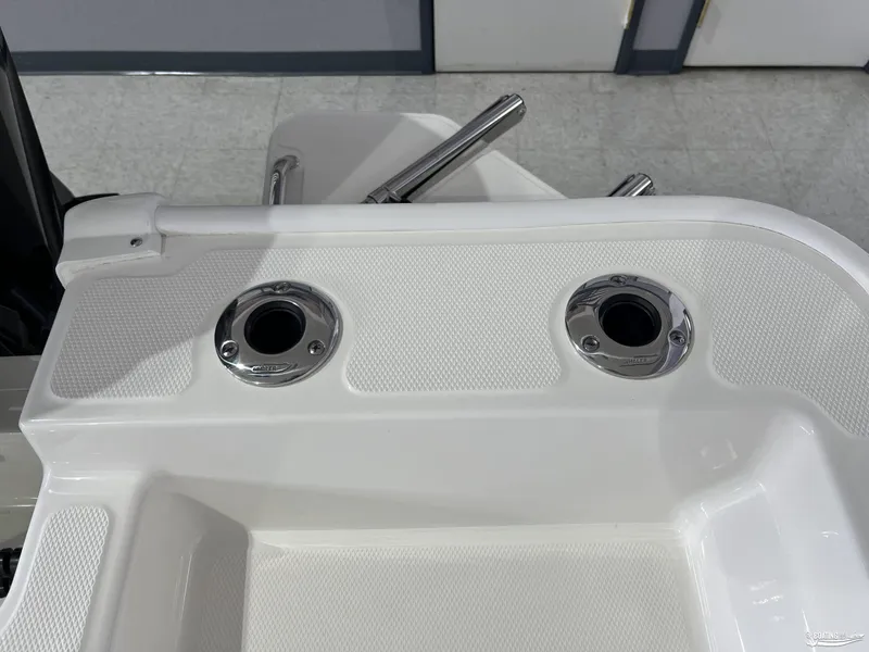 Slide: The Image of Boston Whaler 170 Montauk 2025 boat deck with rod holders and textured surface. - 7