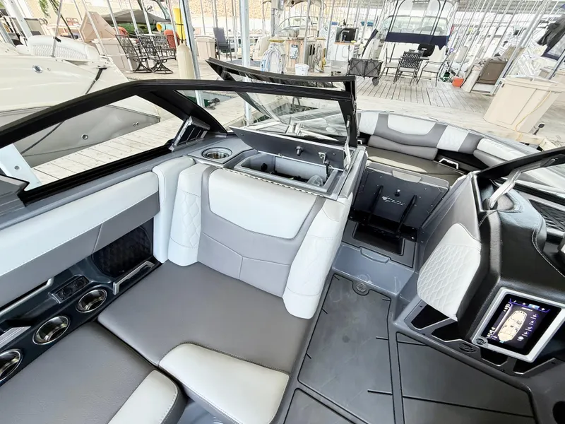 Slide: The Image of 2021 Malibu M240 boat interior with modern seating and sleek design. - 26