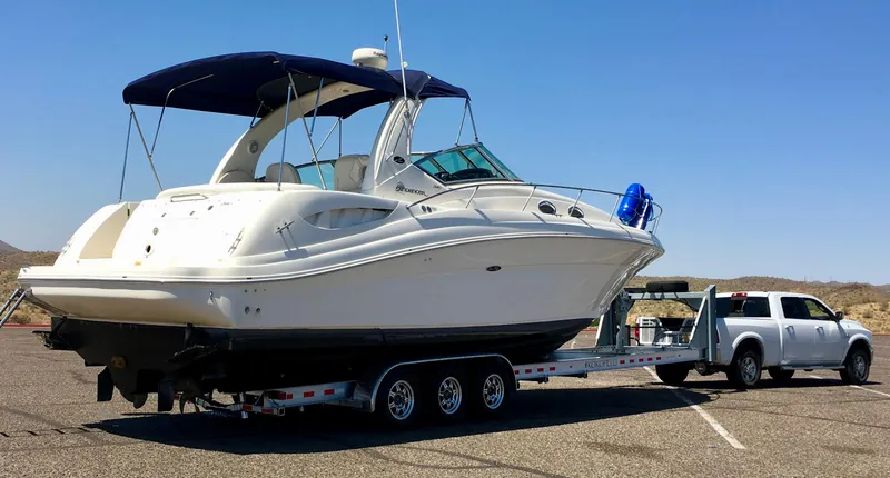 Slide: The Image of 2004 Sea Ray 340 Sundancer boat on trailer, parked in sunny outdoor setting. - 2