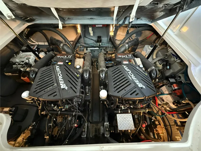 Slide: The Image of 2004 Sea Ray 340 Sundancer engine compartment with dual Mercury engines. - 28
