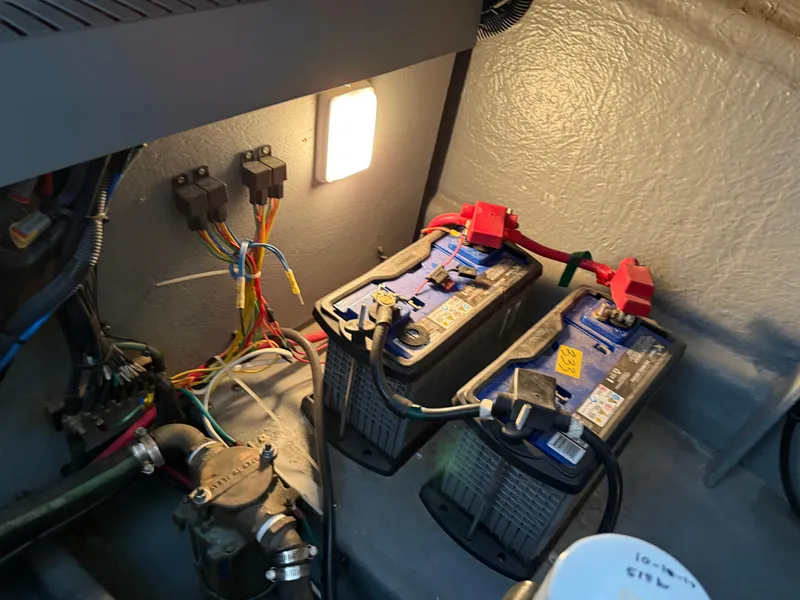 Slide: The Image of 2004 Sea Ray 340 Sundancer engine room with batteries and wiring. - 31