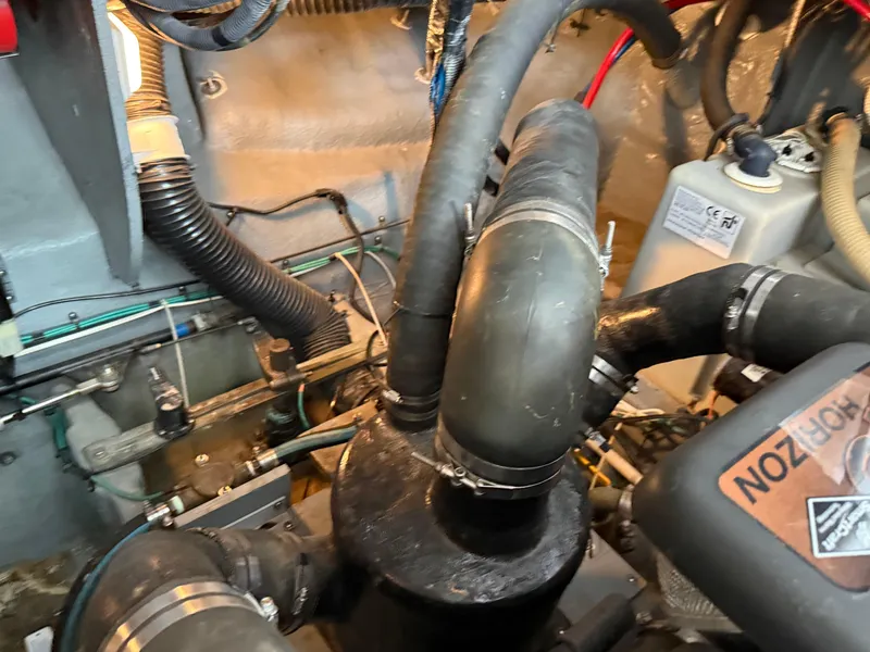 Slide: The Image of Engine room of 2004 Sea Ray 340 Sundancer with visible hoses and components. - 33