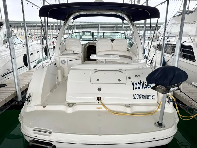 Slide: The Image of 2004 Sea Ray 340 Sundancer docked at marina, rear view with seating area. - 6