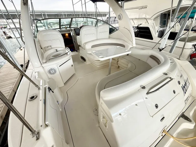 Slide: The Image of 2004 Sea Ray 340 Sundancer boat interior with seating and table, docked at marina. - 8