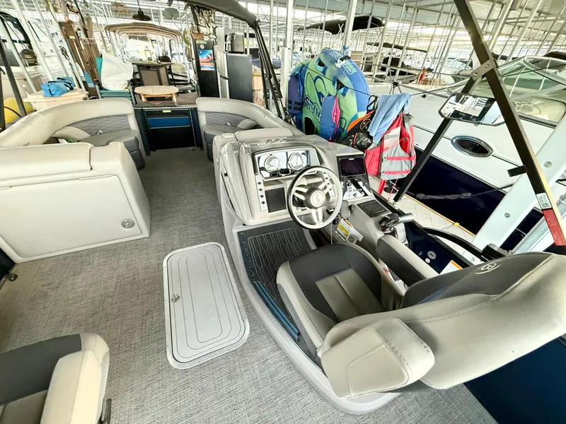 Slide: The Image of 2024 Barletta Corsa 23UC pontoon boat interior with helm, seating, and storage. - 11
