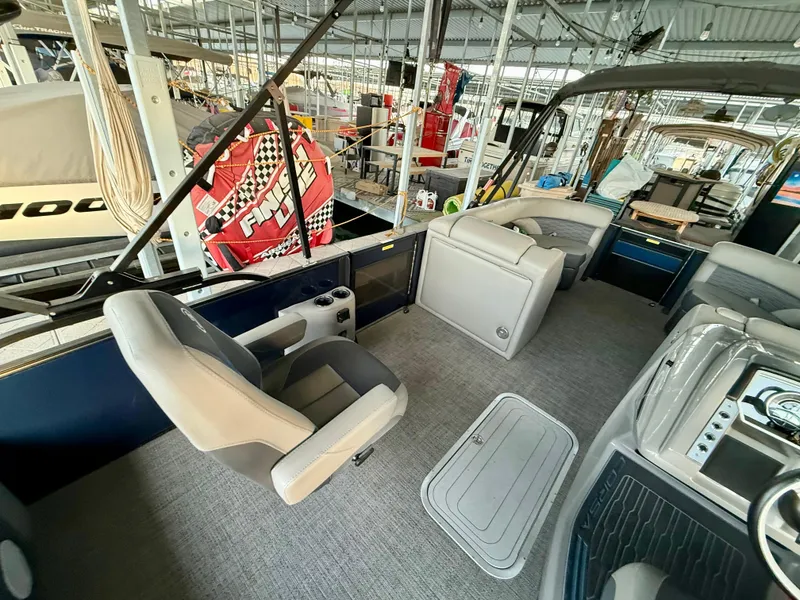 Slide: The Image of 2024 Barletta Corsa 23UC pontoon boat interior with seating and helm. - 14