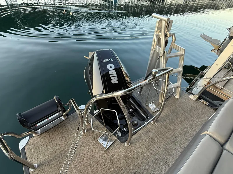 Slide: The Image of 2024 Barletta Corsa 23UC boat with powerful V8 engine on calm water. - 2