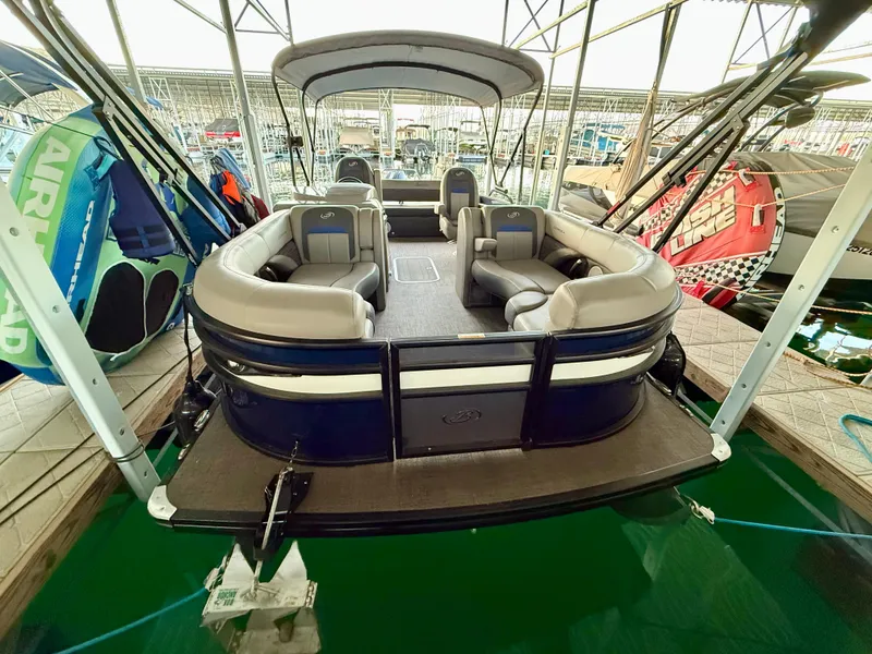 Slide: The Image of 2024 Barletta Corsa 23UC pontoon boat docked, featuring spacious seating and modern design. - 7
