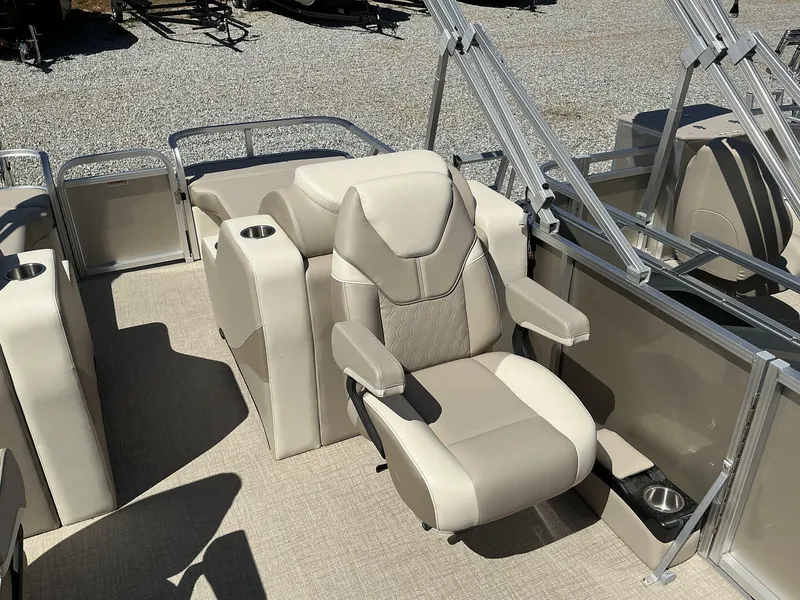 Slide: The Image of 2025 Avalon LSZ 23 FT Rear Lounger boat interior with beige seating and cup holders. - 6