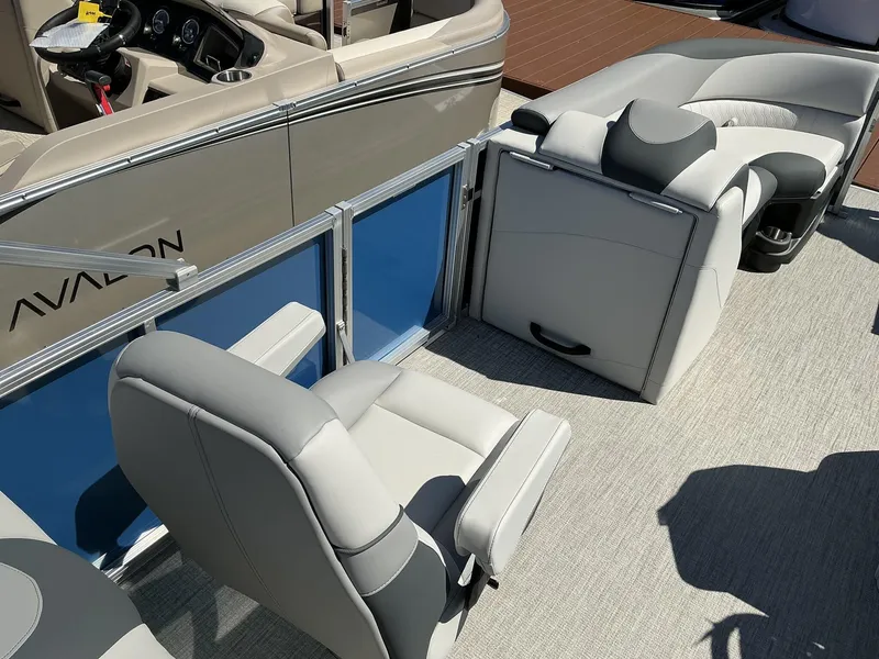 Slide: The Image of 2025 Avalon LSZ - 23 FT boat interior with gray seating and steering console. - 12
