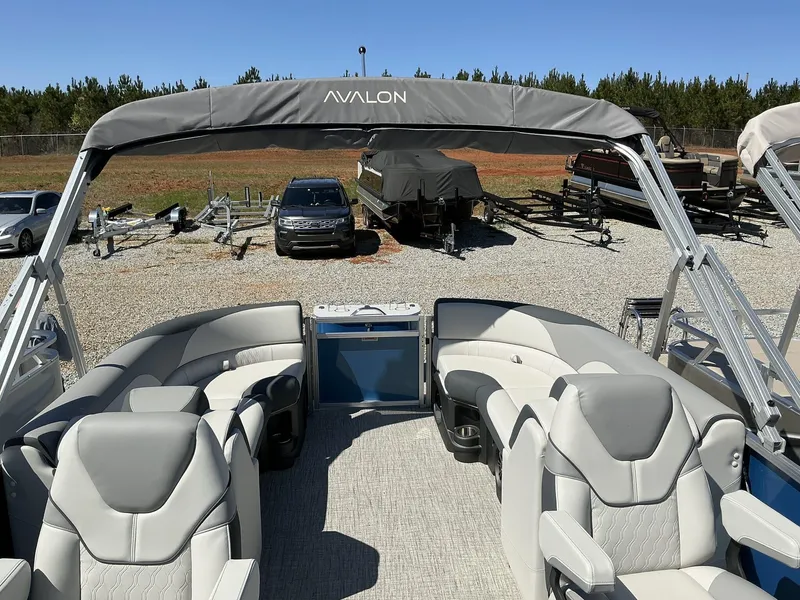 Slide: The Image of 2025 Avalon LSZ - 23 FT pontoon boat with luxurious seating and canopy in a sunny outdoor setting. - 6
