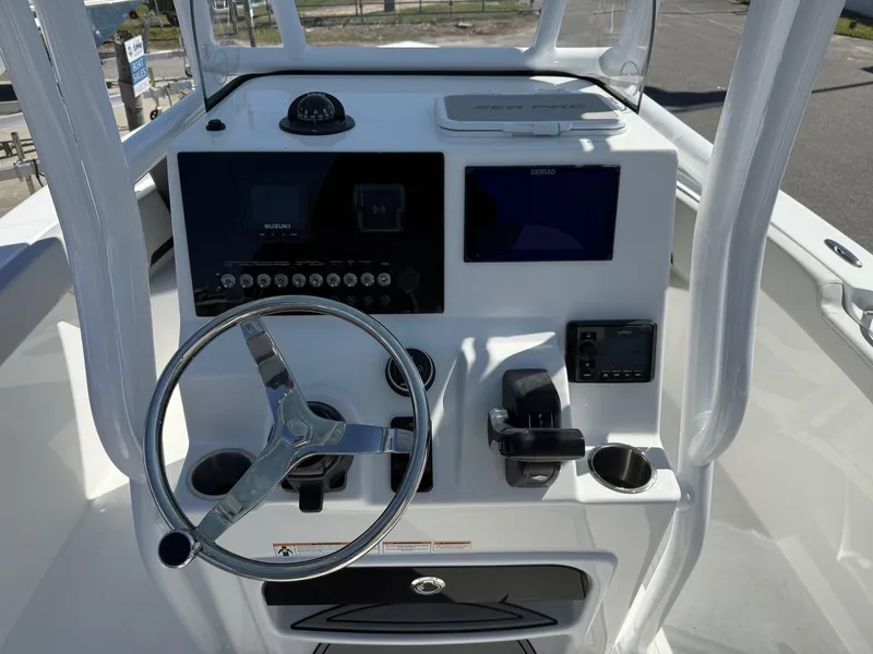 Slide: The Image of 2025 Sea Pro 225FLX SANDBAR boat console with steering wheel and navigation controls. - 11