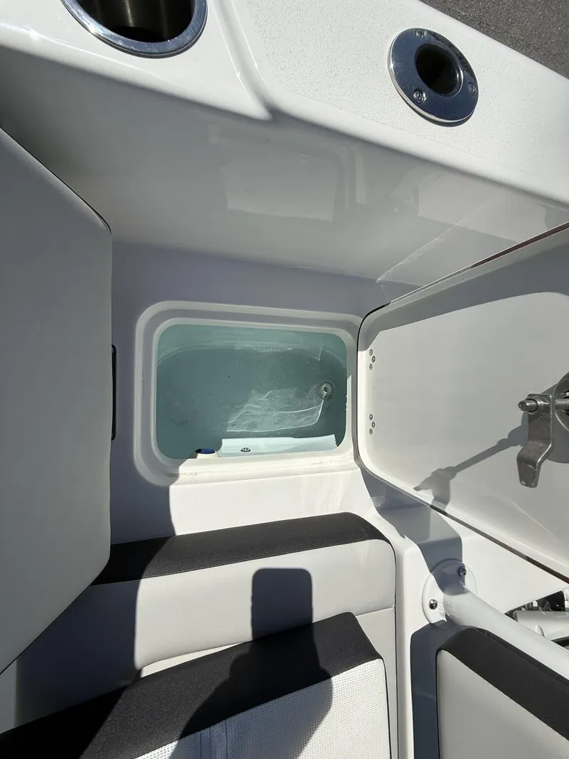Slide: The Image of Interior view of 2025 Sea Pro 225FLX SANDBAR boat, featuring storage compartment. - 17