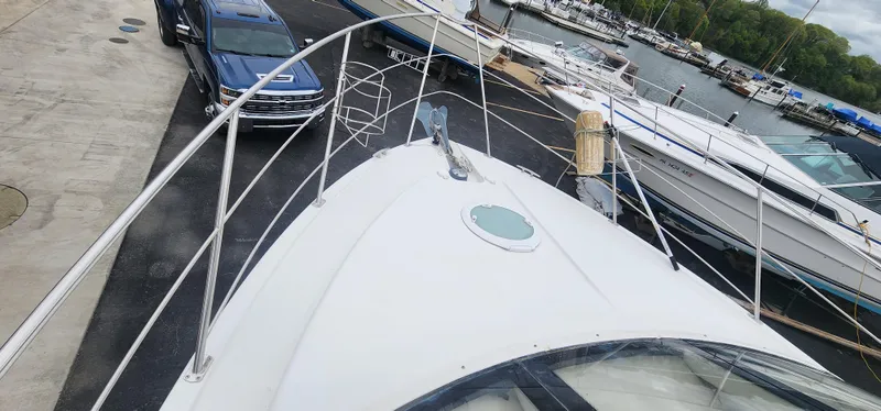 Slide: The Image of 2006 Carver 36 Aft Cabin Motor Yacht docked near a blue truck. - 10