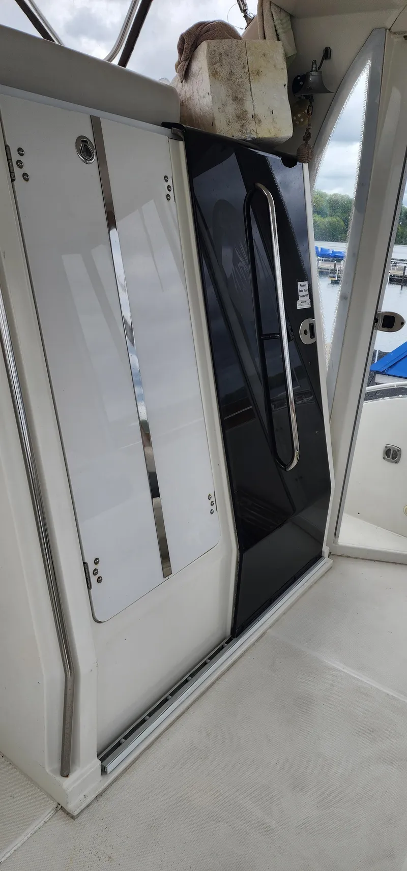 Slide: The Image of 2006 Carver 36 Aft Cabin Motor Yacht interior with sliding doors and marina view. - 25