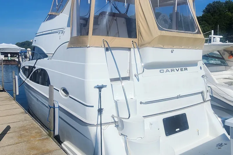 The Image of 2006 Carver 36 Aft Cabin Motor Yacht docked at marina, rear view. - 0