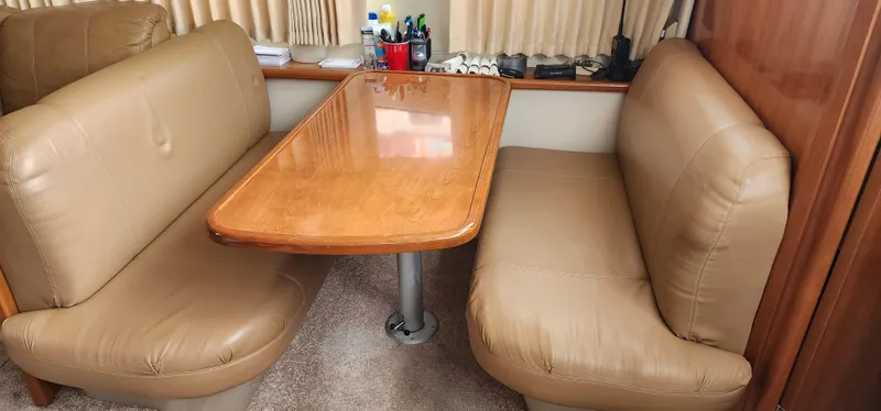 Slide: The Image of Interior of 2006 Carver 36 Aft Cabin Motor Yacht with leather seating and wooden table. - 26