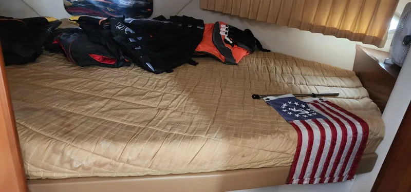 Slide: The Image of Cabin interior of 2006 Carver 36 Aft Cabin Motor Yacht with bed and American flag. - 29