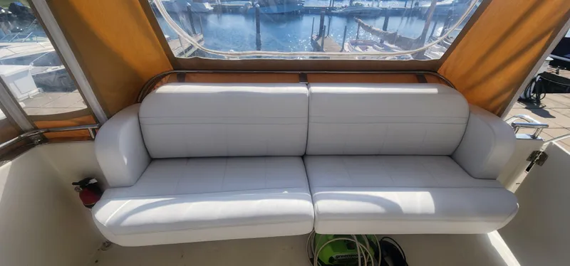 Slide: The Image of White seating area on 2006 Carver 36 Aft Cabin Motor Yacht, with marina view. - 41