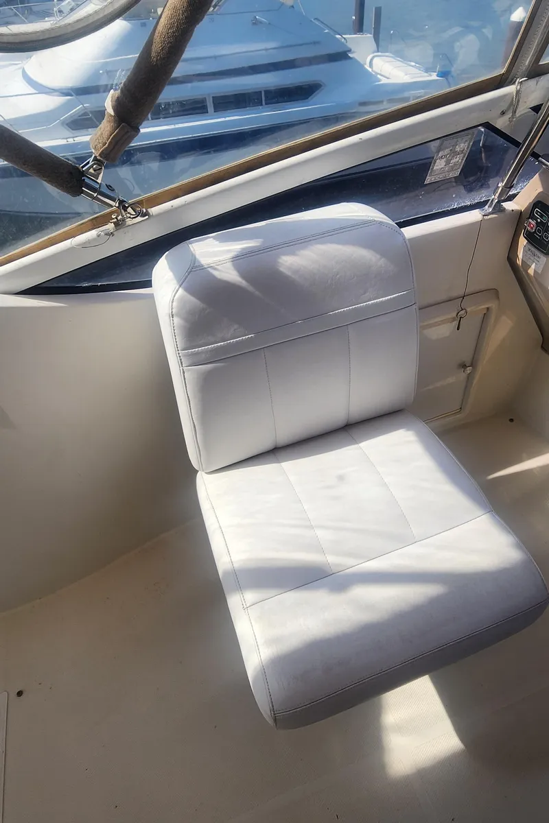 Slide: The Image of White captain's chair in 2006 Carver 36 Aft Cabin Motor Yacht cockpit. - 42