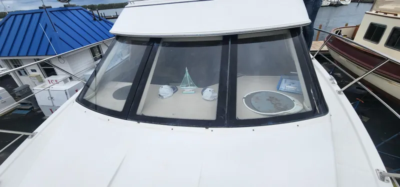 Slide: The Image of 2006 Carver 36 Aft Cabin Motor Yacht docked, showcasing front windows and deck. - 5