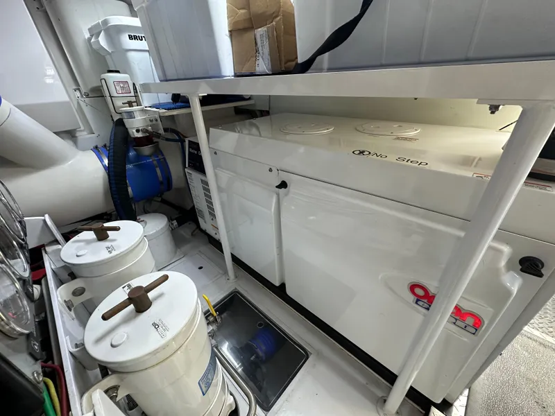 Slide: The Image of Engine room of 2008 Viking 64 Enclosed Bridge with Onan generator and filtration system. - 15