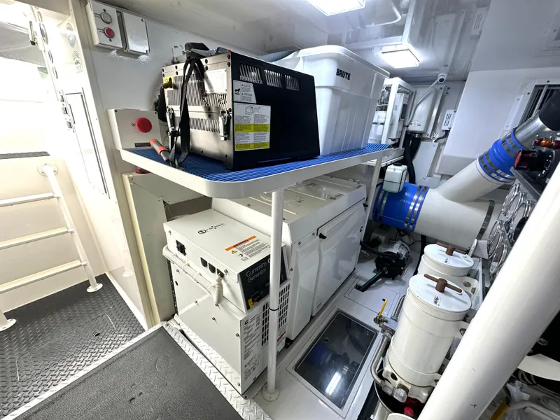 Slide: The Image of Engine room of 2008 Viking 64 Enclosed Bridge yacht, featuring equipment and storage. - 16