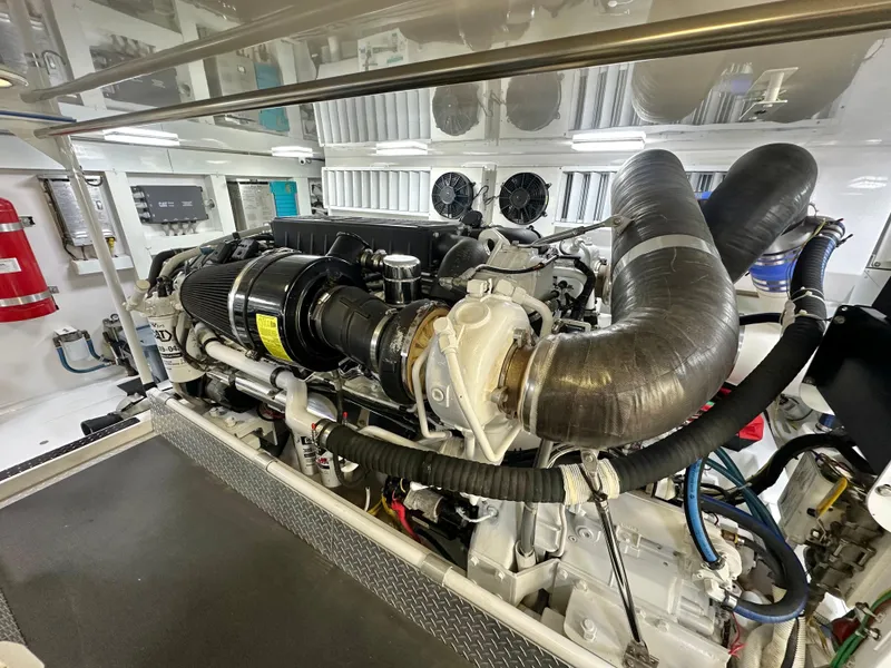 Slide: The Image of Engine room of 2008 Viking 64 Enclosed Bridge yacht, showcasing detailed machinery and components. - 17