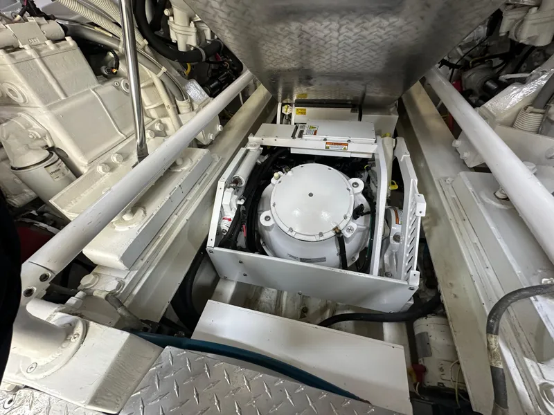 Slide: The Image of Engine room of 2008 Viking 64 Enclosed Bridge yacht, showcasing mechanical components. - 19