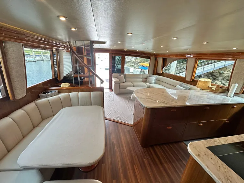 Slide: The Image of Luxurious interior of 2008 Viking 64 Enclosed Bridge yacht with elegant seating and wood finishes. - 21