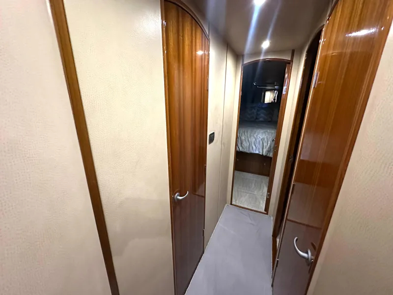 Slide: The Image of 2008 Viking 64 Enclosed Bridge yacht interior hallway with wooden doors. - 24
