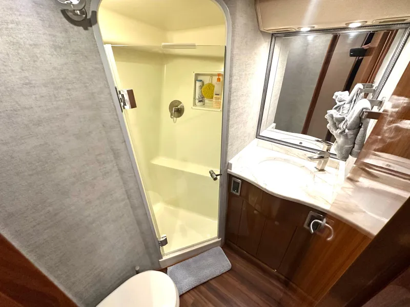 Slide: The Image of Bathroom interior of 2008 Viking 64 Enclosed Bridge yacht, featuring shower and vanity. - 25