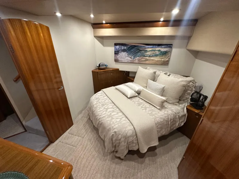 Slide: The Image of Luxurious bedroom interior of 2008 Viking 64 Enclosed Bridge yacht with cozy bedding. - 27
