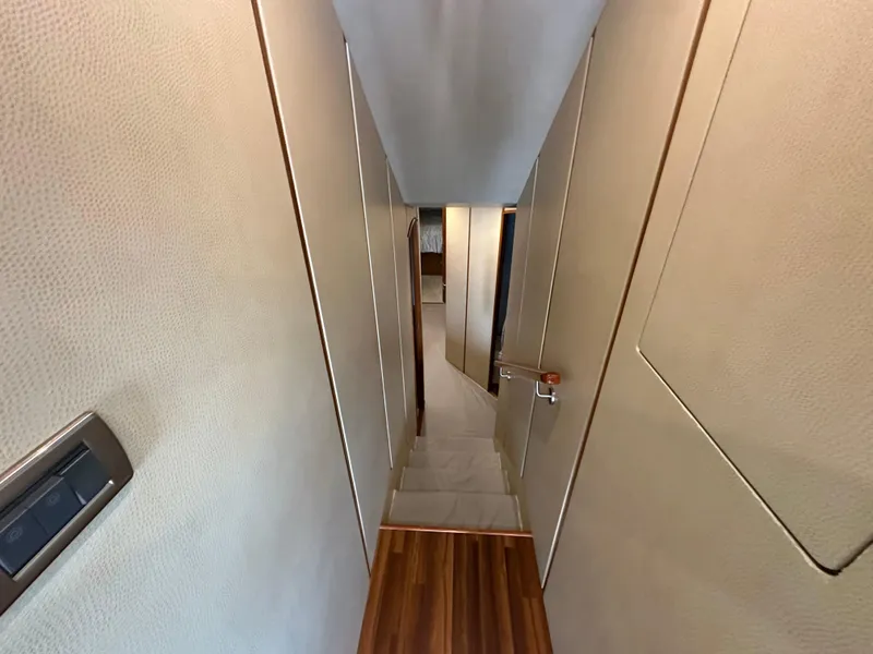 Slide: The Image of Hallway inside 2008 Viking 64 Enclosed Bridge yacht with wooden flooring and beige walls. - 29