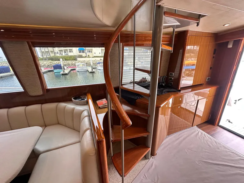 Slide: The Image of Interior of 2008 Viking 64 Enclosed Bridge yacht with spiral staircase and seating area. - 30