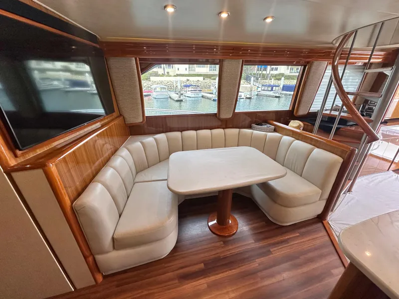 Slide: The Image of Luxurious interior of 2008 Viking 64 Enclosed Bridge yacht with elegant seating and table. - 31