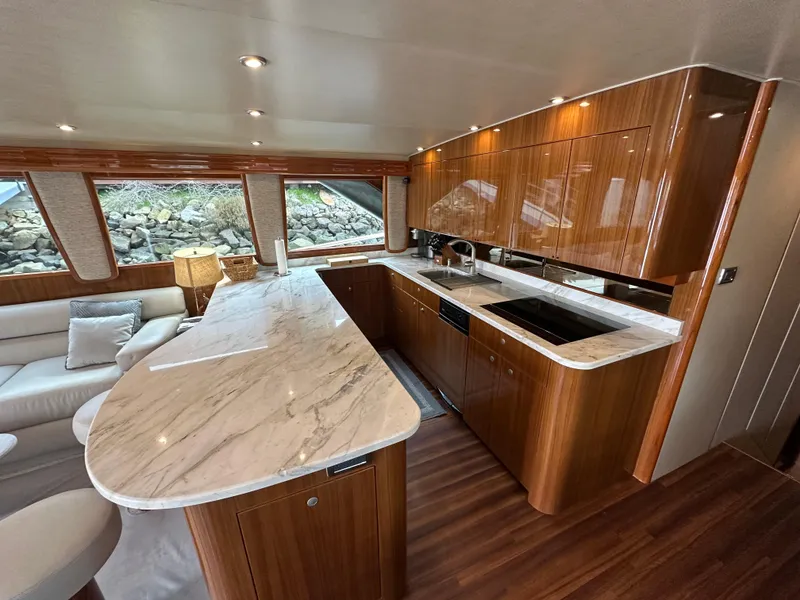 Slide: The Image of Luxurious interior of 2008 Viking 64 Enclosed Bridge yacht with elegant wood and marble finishes. - 33