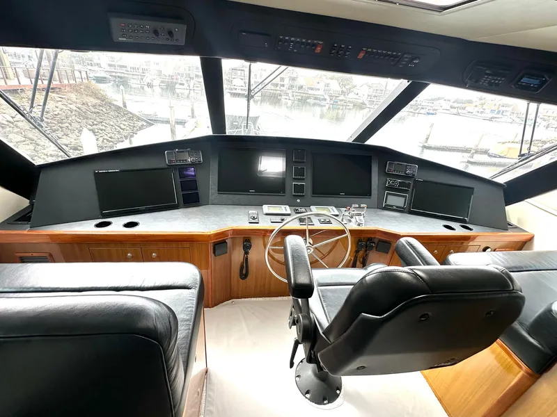Slide: The Image of 2008 Viking 64 Enclosed Bridge helm with leather seating and advanced navigation controls. - 35