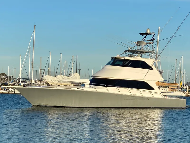 Slide: The Image of 2008 Viking 64 Enclosed Bridge yacht docked in marina, clear sky background. - 36