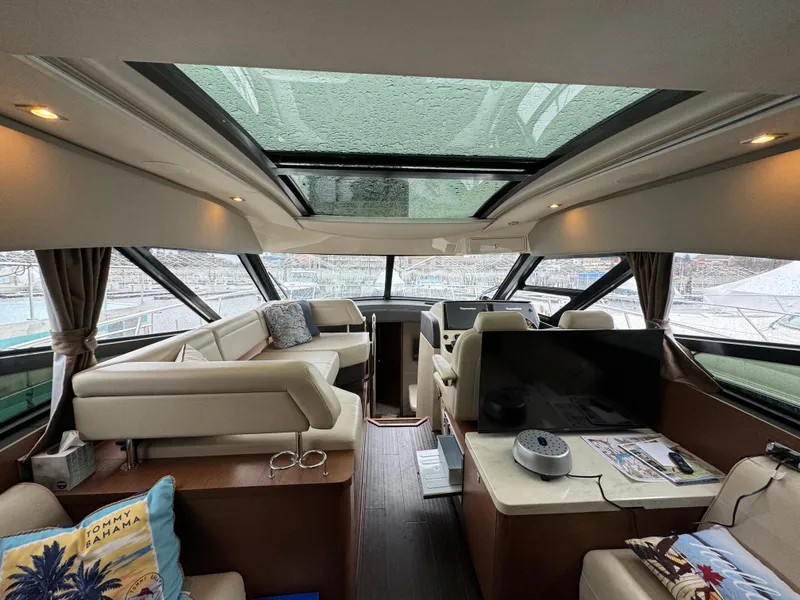 Slide: The Image of Interior of 2016 Sea Ray 470 Sundancer yacht with luxurious seating and panoramic windows. - 10