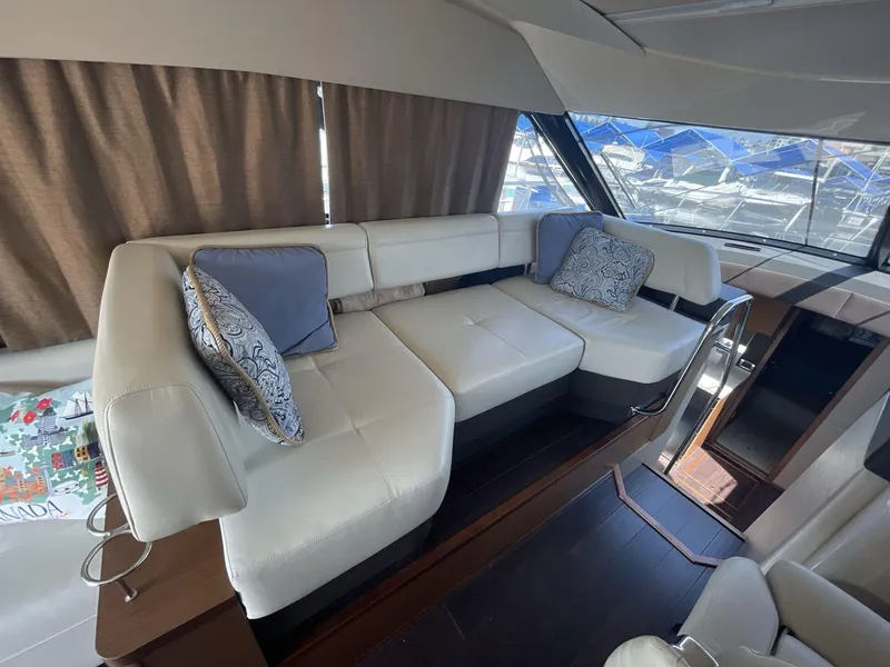 Slide: The Image of Luxurious interior of 2016 Sea Ray 470 Sundancer yacht with plush seating and decorative pillows. - 11